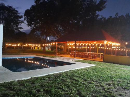 a lit up building with a pavilion with lights at Garden Suites Comalcalco in Comalcalco