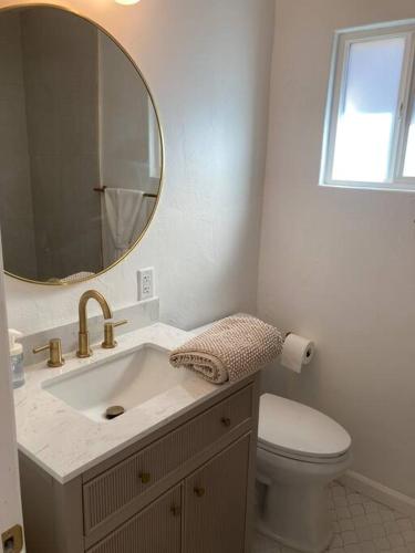 a bathroom with a sink and a toilet and a mirror at University Casa Bonita in Tucson