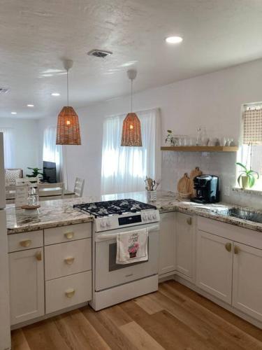 a kitchen with white cabinets and a stove top oven at University Casa Bonita in Tucson
