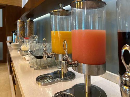 a counter top with two glass containers of juice at Holiday Inn Express Mérida by IHG in Mérida
