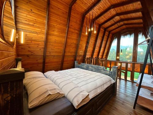 a bedroom with a bed in a wooden room at Doa Bungalov & Tiny House in Sapanca