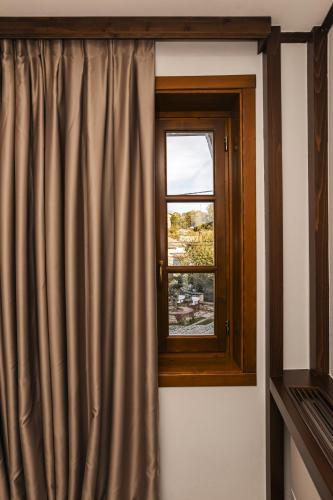 a window with a curtain in a room at N'SOKAK Boutique Hotel in Gjirokastër