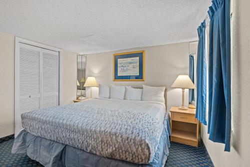 a hotel room with a bed and two lamps at Yachtsman Oceanfront Resort in Myrtle Beach