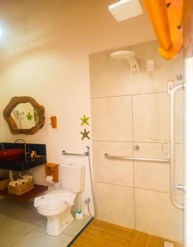 a bathroom with a toilet and a shower at Flats Macapá Meu Amor 11 in Luis Correia