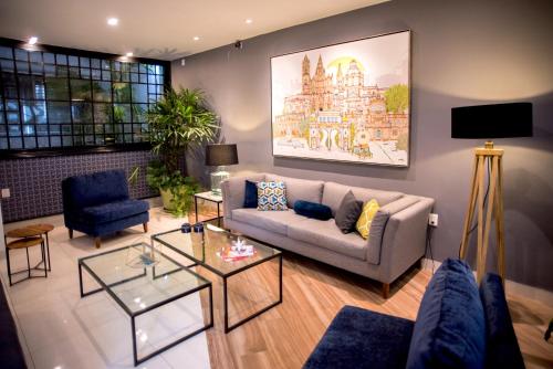 a living room with a couch and a table at Hotel Arboledas Expo in Guadalajara