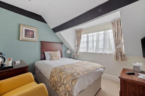 a bedroom with a large bed and a window at Sleeping Bear Hotels Dorchester in Dorchester