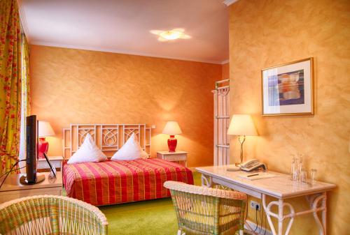 Pokój hotelowy z łóżkiem i biurkiem w obiekcie Campus Garden Businesshotel w mieście Iserlohn