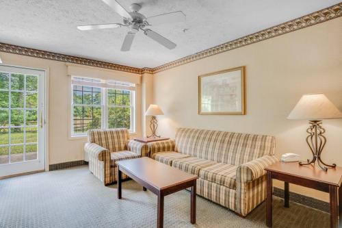 a living room with a couch and two chairs at The Willowbrook Golf Hotel At Split Rock in Lake Harmony