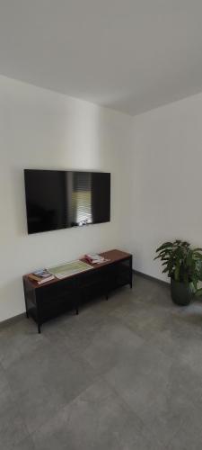 a living room with a table and a flat screen tv at Nowa Osada in Łącko