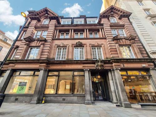 a large brick building with windows on a street at Stunning 2-bedroom Apartment in Manchester Centre in Manchester