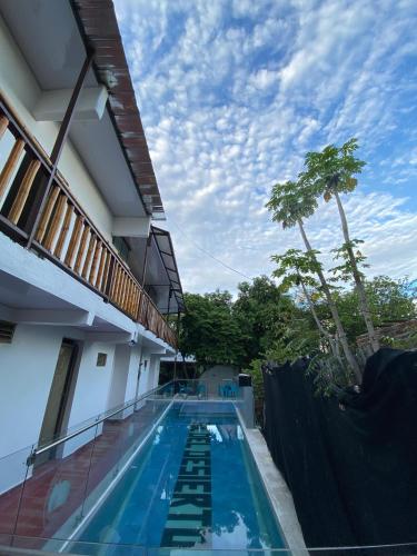 a swimming pool in the side of a building at Hotel Sol del Desierto in Villavieja
