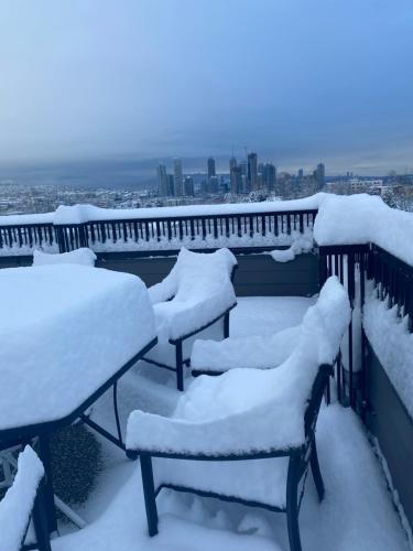 a group of benches covered in snow on a balcony at Panorama VistaVue Vancouver in Vancouver