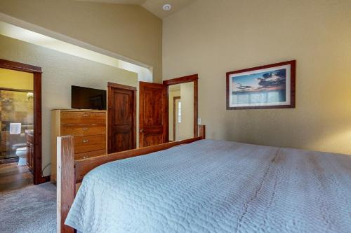 a bedroom with a large bed and a television at Stonewood Cabin in Sunriver