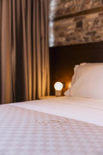 a close up of a bed in a bedroom at N'SOKAK Boutique Hotel in Gjirokastër