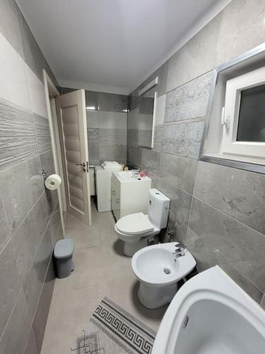 a bathroom with two toilets and a sink at Studio in Sibiu