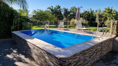a swimming pool with a brick wall around it at Villas de encanto in Vilamarxant