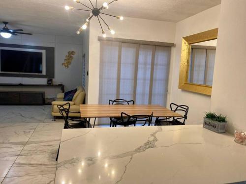 a living room with a wooden table and chairs at Casa de lujo a 7min de consulado in Ciudad Juárez