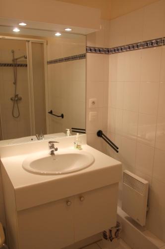 une salle de bain avec un lavabo et un miroir dans l'établissement Le 7 Augustin, à Nice