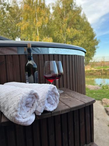 a glass of red wine and a bottle of wineearcher at Samosiejka SPA Słońsko in Słońsko