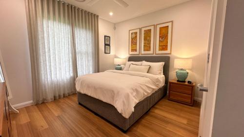 a bedroom with a large bed and a window at The Getaway - Galston in Galston
