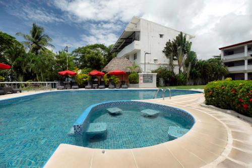 a large swimming pool in front of a building at Jaco Laguna Resort & Beach Club in Jacó