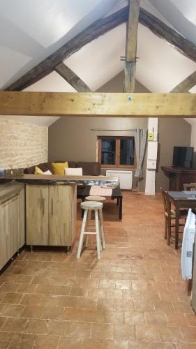 a kitchen with a table and a stool in a room at Gîte du Ka'lao in Saint-Julien
