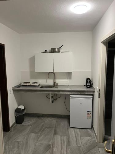 a kitchen with a counter and a sink in a room at Apartment Krasniqi in Hönigsberg