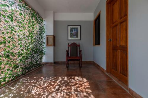 a hallway with a door and a chair and a wall at Jaco Laguna Resort & Beach Club in Jacó