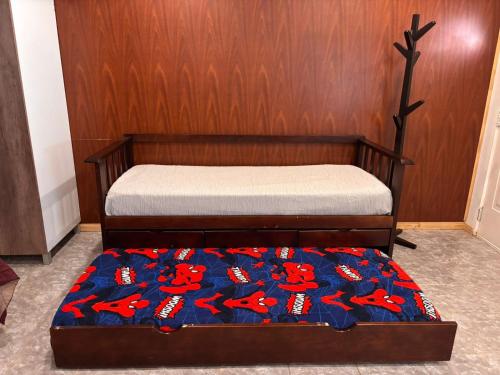 a bedroom with a bed with a wooden wall at Descanso Río Grande in Río Grande