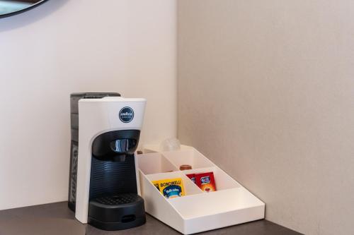 a coffee maker with a box next to it at Ambrosia Room & Apartment in Rossano