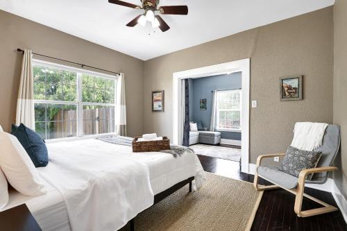 a bedroom with a bed and a window and a chair at Pearl - A Birdy Vacation Rental in San Antonio