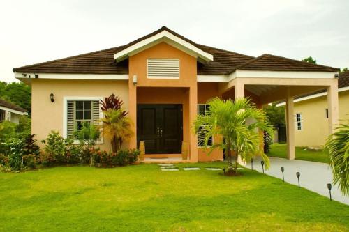 a house with a green lawn in front of it at Paradise in Edgehill, Jamaica! in St Mary