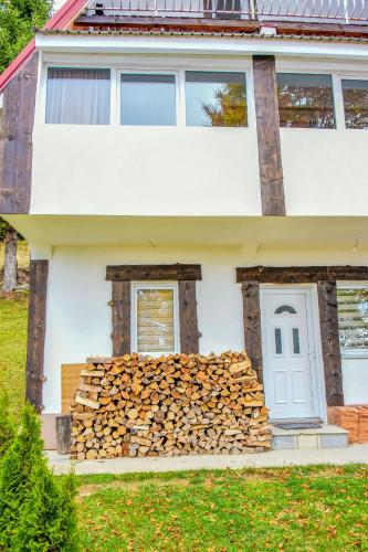 a pile of fire wood in front of a house at Vikendica Čeperković #1 in Kopaonik
