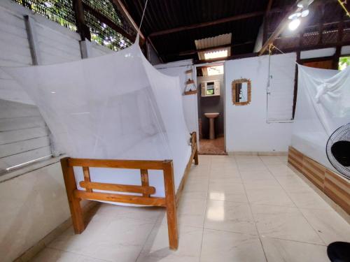 a wooden chair in a room with white walls at Eco Hotel Campo Verde in Isla Grande