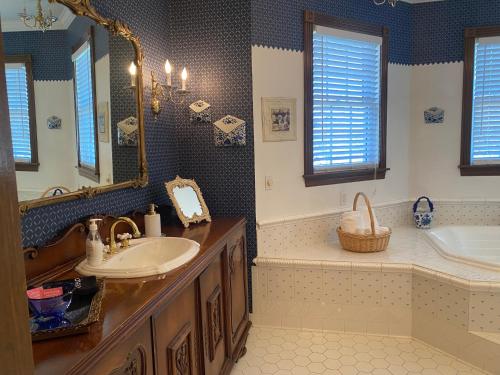 a bathroom with a sink and a tub and a mirror at Apple Crest Inn in Gentry