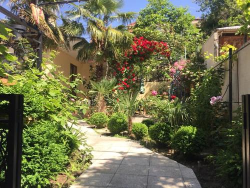 a garden path with flowers and plants on a house at House 41 in Tbilisi City