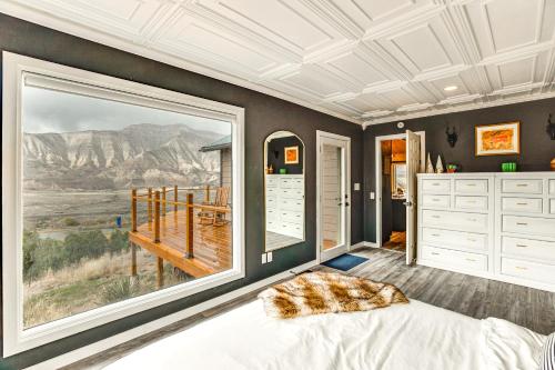 a bedroom with a bed and a large window at Colorado River Getaway in Parachute Dogs Welcome! in Parachute