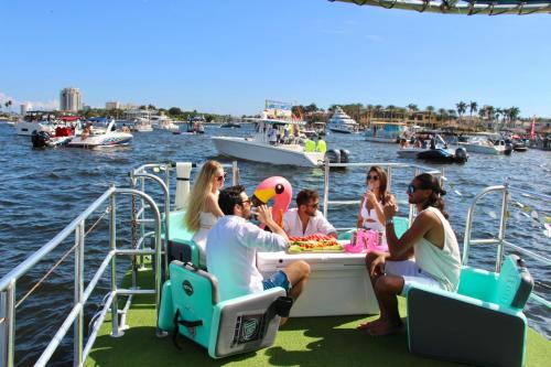 a group of people sitting at a table on a boat at Lux House Heated Spa & Free Boat Tour! in Fort Lauderdale