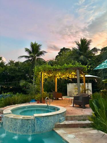 a swimming pool in a yard with a pergola at Campito Loving in Higuey