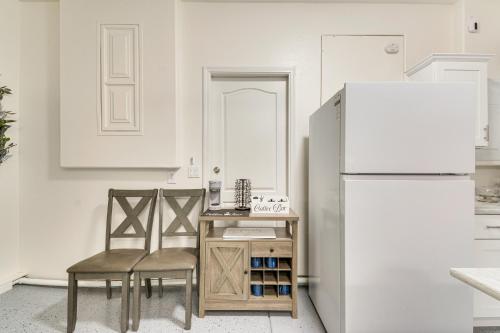a kitchen with a white refrigerator and two chairs at 10 Mi to Yosemite Lake Atwater Retreat in Atwater