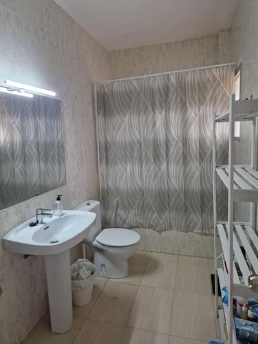a bathroom with a sink and a toilet and a shower at Large chalet 5 min walk to beach in Vélez-Málaga