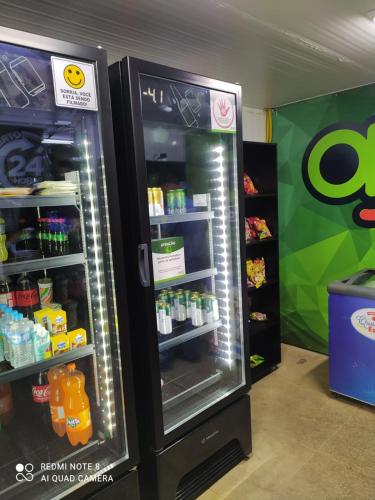two refrigerators in a store with their doors open at Lar feliz in Juiz de Fora