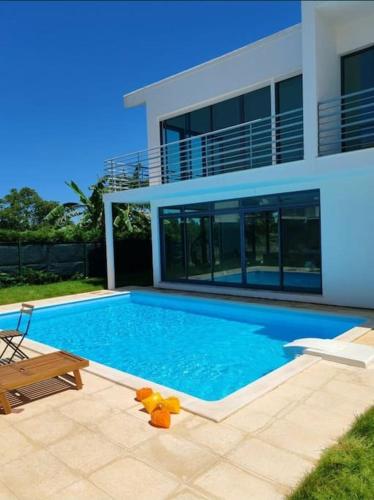 a swimming pool with a teddy bear in front of a house at Villa Palmela Resort V5 Piscina privado in Quinta do Anjo
