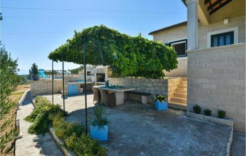 a patio with a table and an umbrella at House Ita in Postira