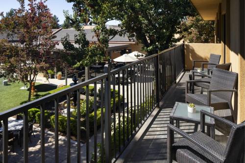 a balcony with chairs and tables and a fence at Napa Valley Marriott Hotel & Spa in Napa