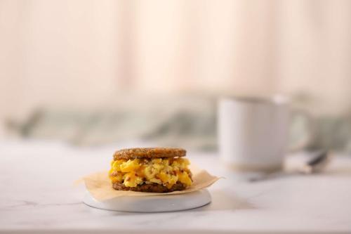 a breakfast sandwich on a plate on a counter at Drury Inn & Suites Middletown Franklin in Middletown