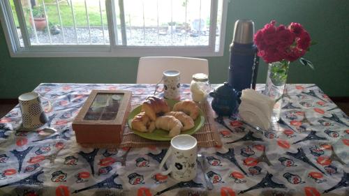 a table with a plate of pastries on it at Habitación y baño privado, en SN Bienestar y calma in San Nicolás de los Arroyos