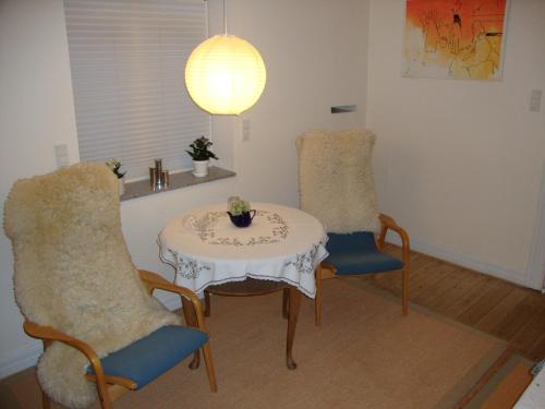 a dining room with a table and two chairs at Klosterpensionen Annex in Viborg