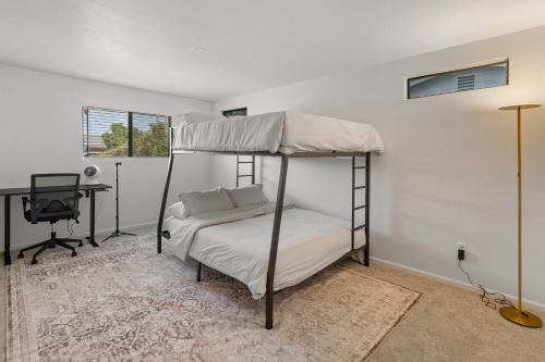 a bedroom with a bunk bed and a desk at NEW Modern Tempe Home with Pool 4bd 2ba in Tempe