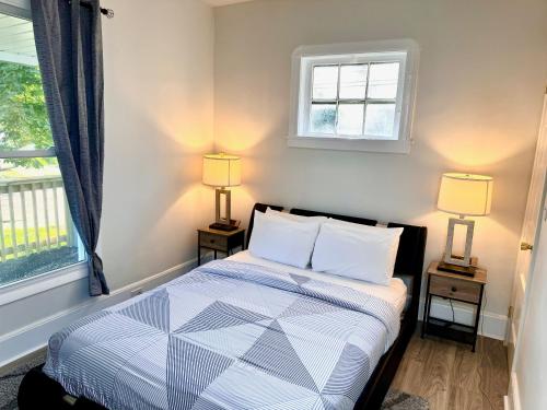 a bedroom with a bed with two lamps on two tables at The House Hotels - Henninger Lower V1 in Cleveland